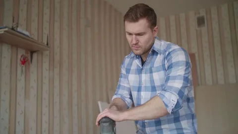 Carpenter uses a grinding machine to align Stock Footage 153495546