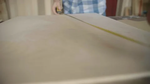 Carpenter uses roulette to measure for work Stock Footage 153495768