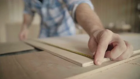 Carpenter uses roulette to measure for work Stock-Footage 153495783