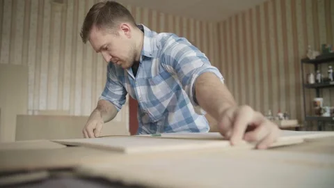 Carpenter uses roulette to measure for work Stock Footage 153495805