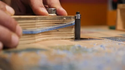 Carpenter uses router to shape sunglass frame made from old skateboards Stock-Footage 134548491
