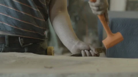 Carpenter using chisel and hammer to chisel wooden board Stock Footage 87613506