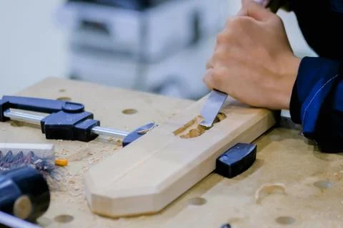 Carpenter using chisel to carve wood Stock Photos