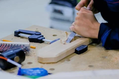 Carpenter using chisel to carve wood Stock Photos