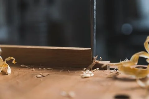 Carpenter using a chisel to carve wood - Carpentry craftsmanship and handwork Stock Photos