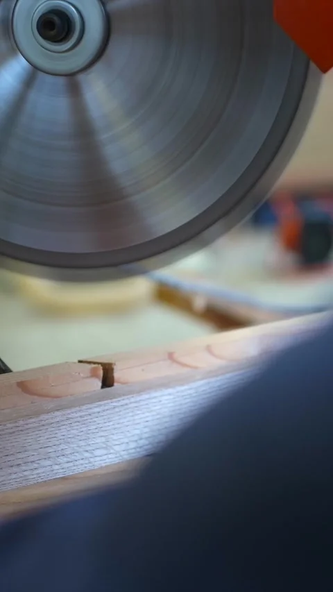 Carpenter using circular saw to cut wooden lath with precision in workshop Видео 332816333