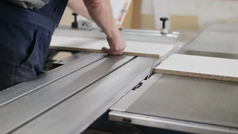 Carpenter using circular saw for cutting wooden board at the workshop Stock Footage 106555315