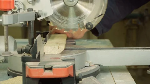 Carpenter using circular saw for cutting wooden board. 库存影片 129176896