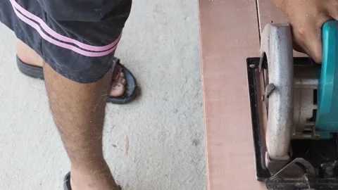 Carpenter using circular saw cutting wooden board in carpentry workshop Stock Footage 155983160