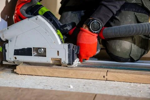 Carpenter Using Circular Saw with Dust Extraction System Photos
