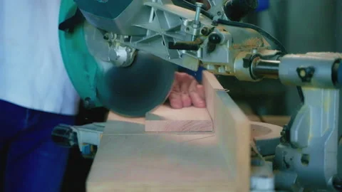 Carpenter is using circular saw for sawing wooden detail in his working studio Stock Footage 197388153
