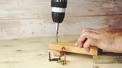 A carpenter is using a cordless drill to unscrew the screws. Stock Footage 169163579