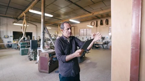Carpenter using a digital tablet for quality control Video stock 347003772