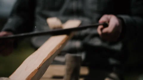 Carpenter using drawknife on shave horse to carve plank straight, slow motion Stock Footage 271190475
