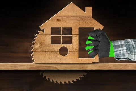Carpenter Using Electric Circular Saw in the Shape of a Wooden Model House Stock Photos