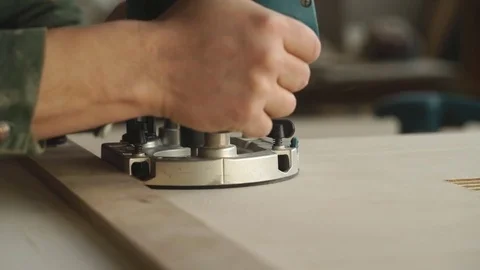 Carpenter using electric grinding machine Stock Footage 76277878