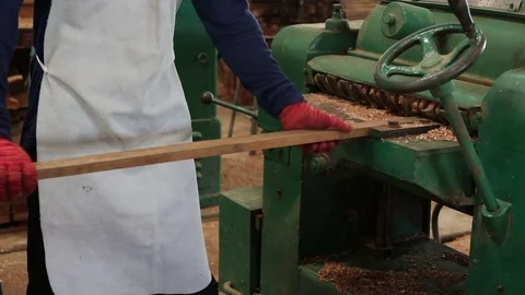 Carpenter using electric planer with wooden plank in carpentry workshop. Stock Footage 79782516