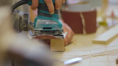 A Carpenter using electric sander on wooden block in workshop Video stock 155539020