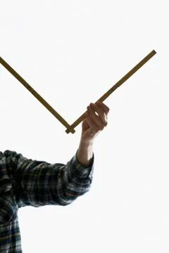 A carpenter using a folding ruler Stock Photos