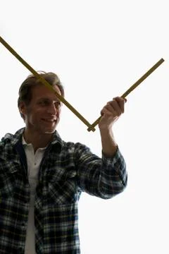 A carpenter using a folding ruler Stock Photos