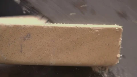  Carpenter using a handsaw and sawing a wooden plank in slow motion 스톡 동영상 77056396