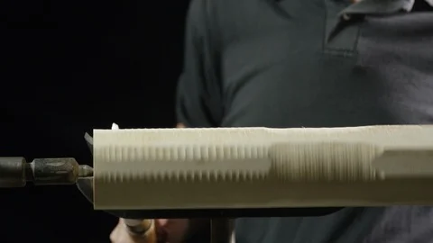 Carpenter using lathe machine to shape the wood in workshop Stock Footage 104222366