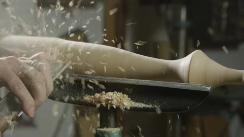 Carpenter using lathe machine to shape the wood in workshop Stock Footage 104223698