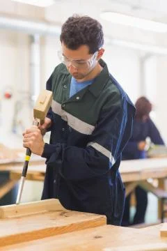 Carpenter using mallet and chisel Stock Photos