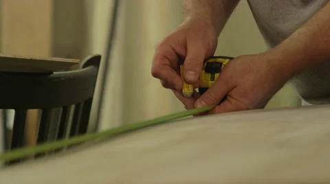 Carpenter Using Measuring Tape to Mark Section of Plywood 動画素材 61503773