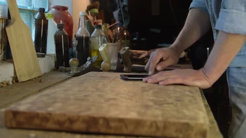 A carpenter using a mobile phone in his workshop Video stock 131966486