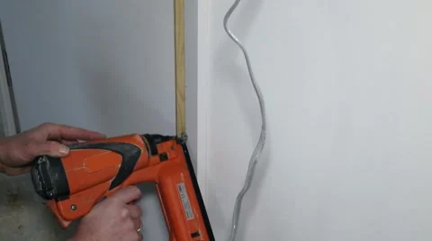 Carpenter using a nailgun Stock Footage 46669765