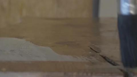 Carpenter using paint brush to varnish wood Stock Footage 139449223