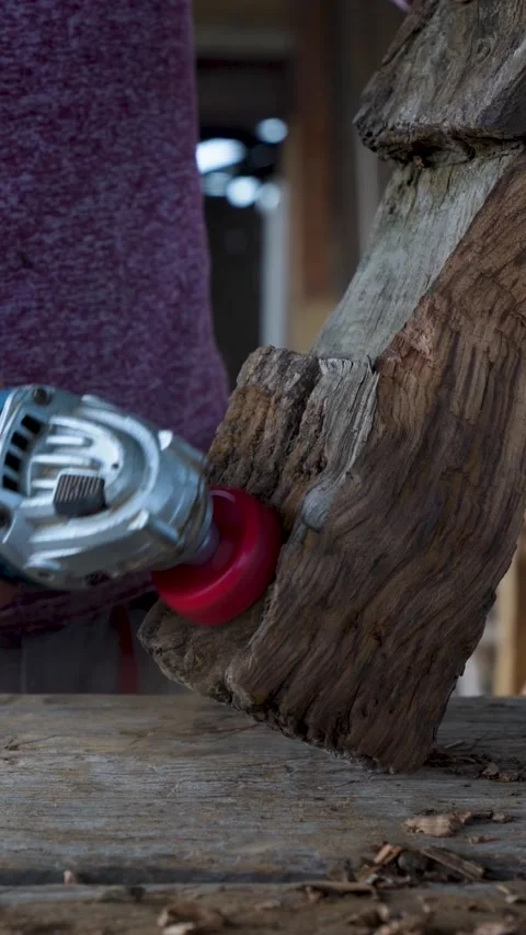 Carpenter using power sander to restore rustic wooden Stockbeeldmateriaal 325204719