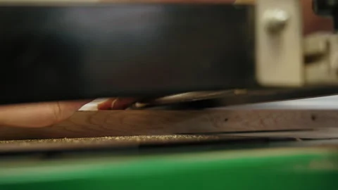 Carpenter using professional wood surface planer machine to produce flat surface Stock Footage 241585798