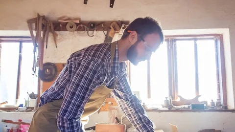 Carpenter using rasp in the carpentry. RAW video record. Stockbeeldmateriaal 84551665