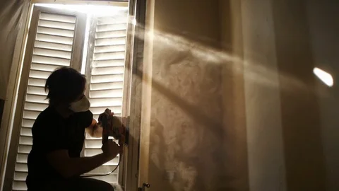 Carpenter using sanding machine to repair old wooden window Stock Footage 81885348