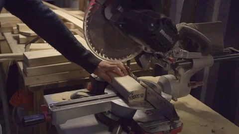 Carpenter using a sawing machine (circular saw) in a working place Stock-Footage 82868519
