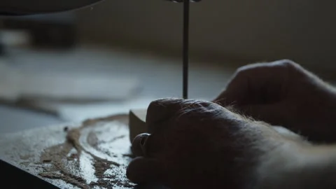 Carpenter using table saw to cut block of wood in workshop Stock Footage 312712379