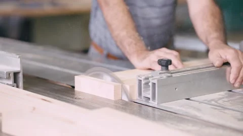 Carpenter using table saw to cut wooden board Stock Footage 337882373
