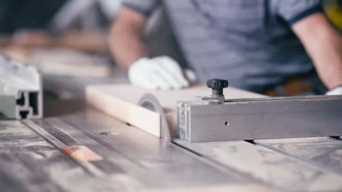 Carpenter using table saw for cutting wood plank Stock Footage 337882396