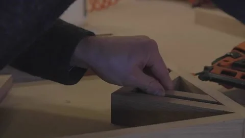 Carpenter using tools to create detailed wall piece Stock Footage 139449281