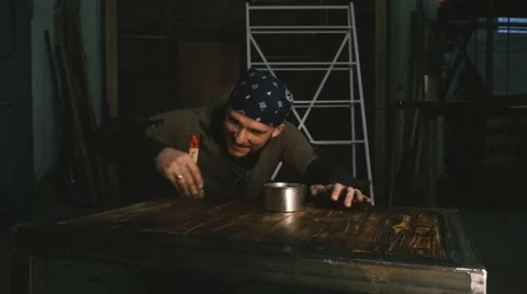Carpenter varnishes table. Close-up Stock Footage 58966694