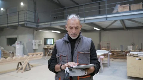 Carpenter walking in workshop, using tablet Stock Footage 123162953
