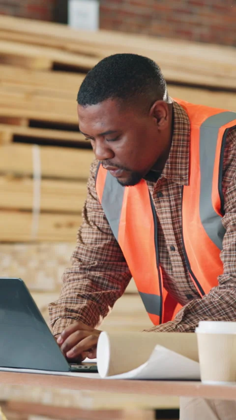 Carpenter, warehouse and black man with laptop for wood production, shipping or Stock Footage 343817153