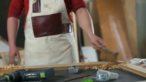 Carpenter wearing goggles standing in the workshop and talking on the phone Stock Footage 74509038