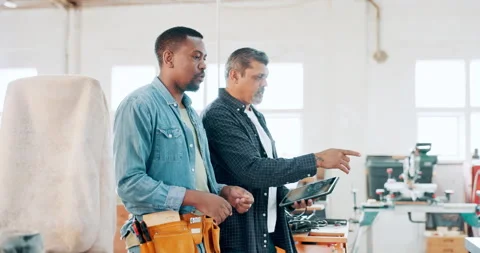 Carpenter, woodwork and apprentice with mentor in workshop, discussion and Stock Footage 263599966