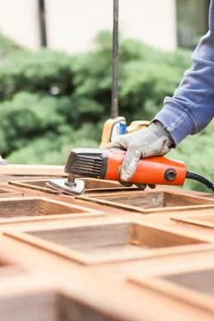 Carpenter at work with angular Sander. Stock Photos