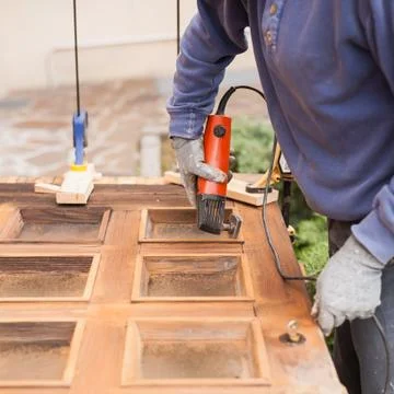 Carpenter at work with angular Sander. Stock Photos