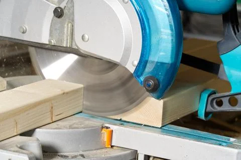 Carpenter work with circular saw for cutting wood bar, the man sawed bars, co Stock Photos