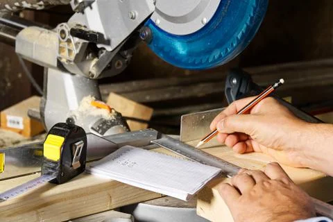 Carpenter work with circular saw for cutting wood bar, the man sawed bars, co Stock Photos